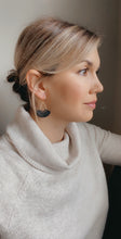 Load image into Gallery viewer,  Matte gold cirrus earrings in black